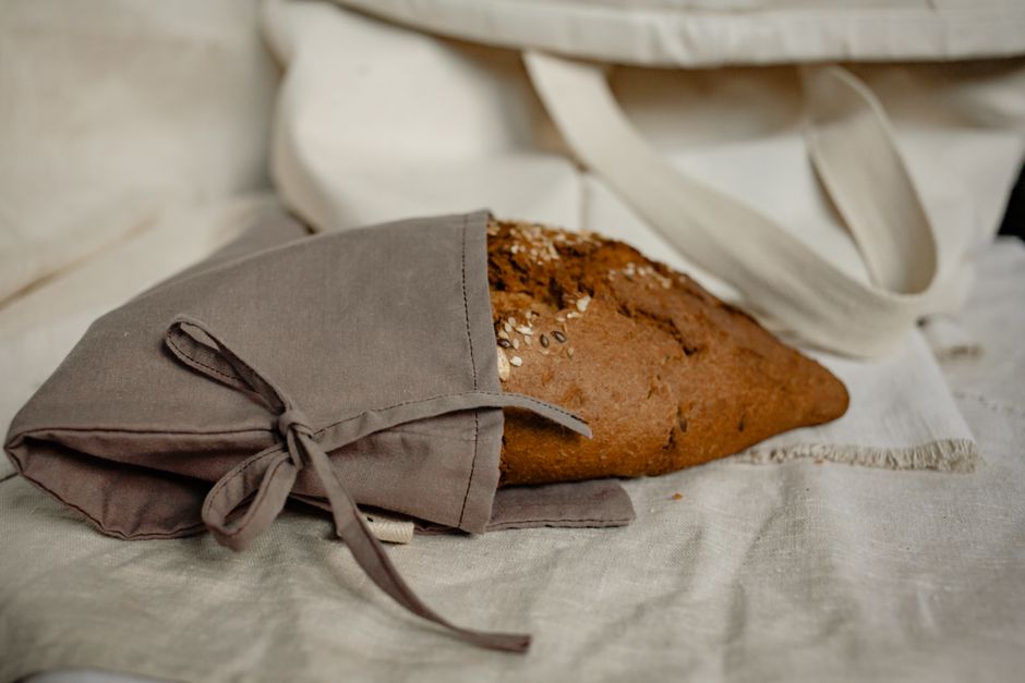 A close-up of homemade bread wrapped in a rustic fabric, perfect for healthy living and traditional baking.